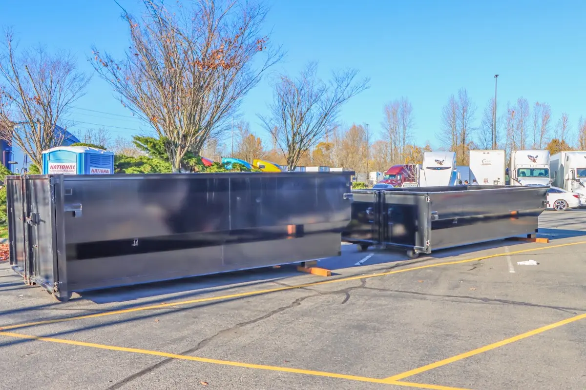 Professional dumpster rental service with roll-off container on residential driveway in Bridgewater